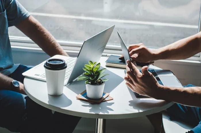Two people reviewing an application on a laptop
